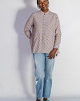 Model wearing linen top with small flower print.