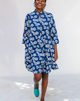 Model wearing blue and white floral dress.