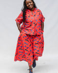 Model wearing red cat print shirt and culotte.