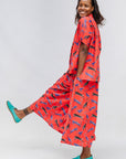 Model wearing red cat print shirt and culotte.