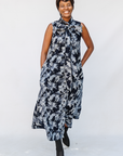 Model wearing navy and gray abstract print maxi dress.