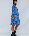 Model wearing blue shaded leaf print dress.