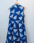 Display of blue sleeveless dress with white triangle print.