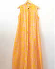 Display of yellow sleeveless dress with abstract pink print.