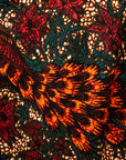 Close up display of orange, brown and green dress, fabric.