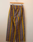 Display of yellow pants with blue zig zag pattern.