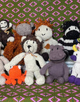 Collection of stuffed animals on a patterned fabric background