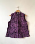 Display of black and purple floral print sleeveless shirt.