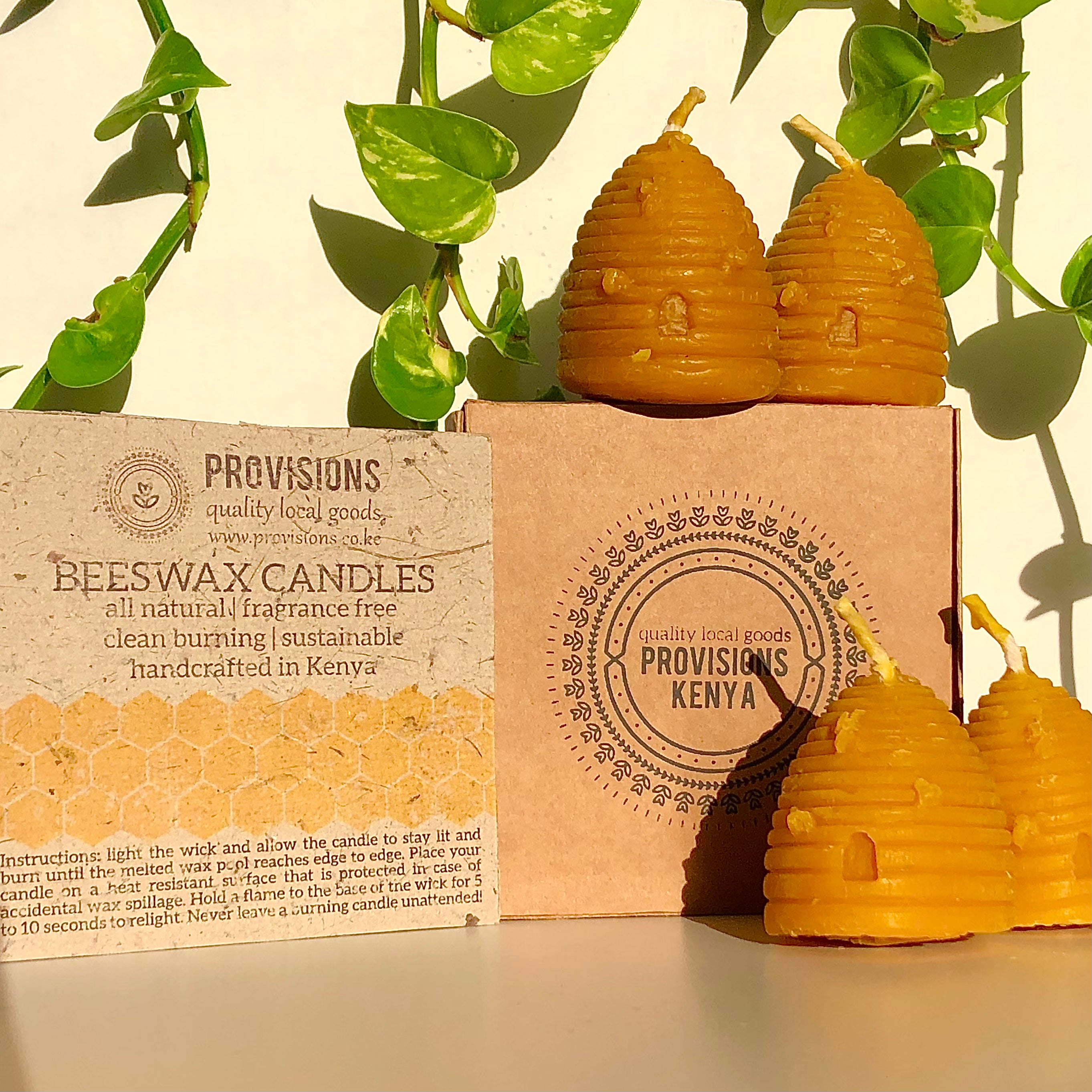 display of 4 bee hive shaped, beeswax candles