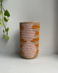 Display of bubble gum pink , orange and beige colored vase