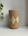 Display of beige, white and yellow colored vase