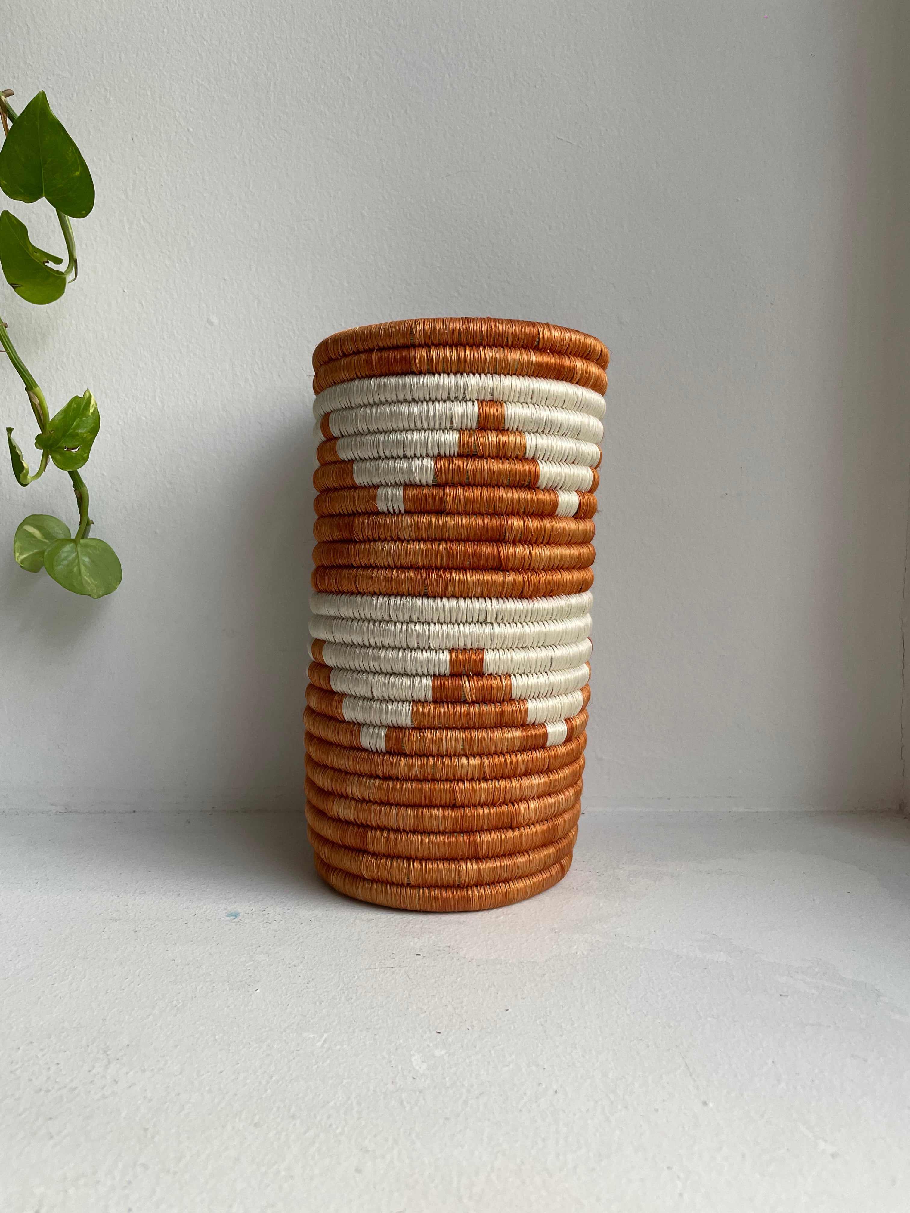 Display of orange and white triangle vase