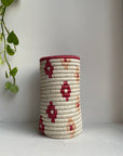 Display of white vase with burgundy flowers