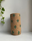Display of beige vase with teal and gold flowers