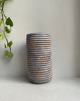 Display of beige and dusty blue vase with geometric design