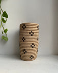 Display of beige and brown colored vase with floral design