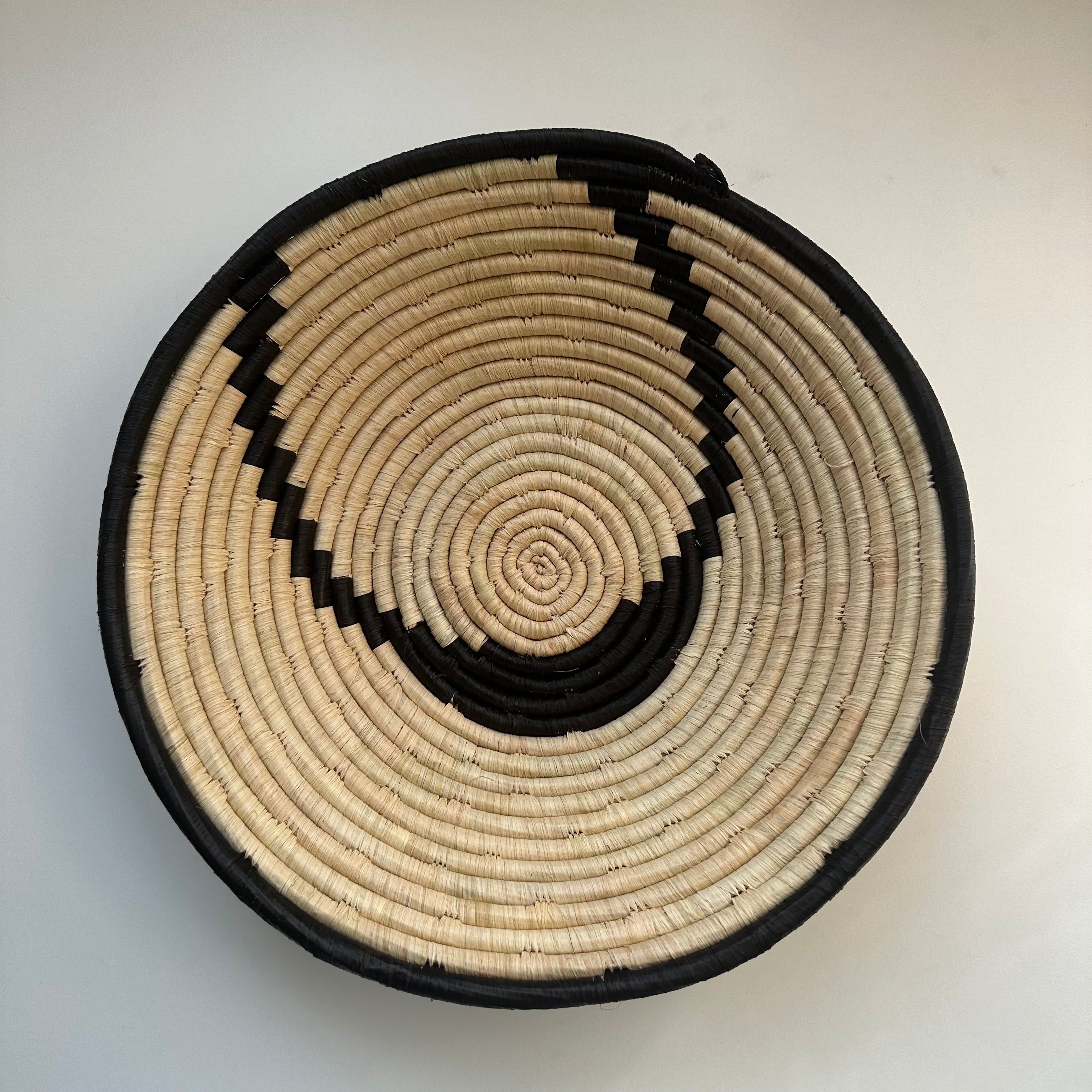 The display of black and natural color woven bowl