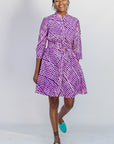 Model wearing purple and pink plaid batik dress.