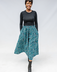 Model wearing aqua, black and white culottes.