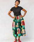 Model wearing multicolored geometric print skirt.