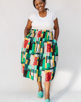 Model wearing multicolored geometric print skirt.