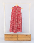 Display of red sleeveless dress with white dots.