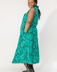 Model wearing teal floral maxi dress.