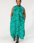 Model wearing teal floral maxi dress.