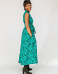 Model wearing teal floral maxi dress.