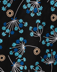 Close up display of black dress with blue and beige floral print, fabric.