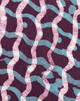 Close up display of purple and blue batik dress, fabric.