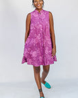 Model wearing purple dress with pink beet print.