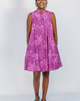 Model wearing purple dress with pink beet print.