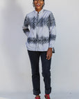 Model wearing white and black batik shirt.