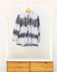 Display of white and black batik shirt.
