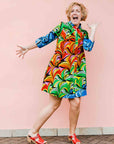 model wearing a rainbow swirl design dress