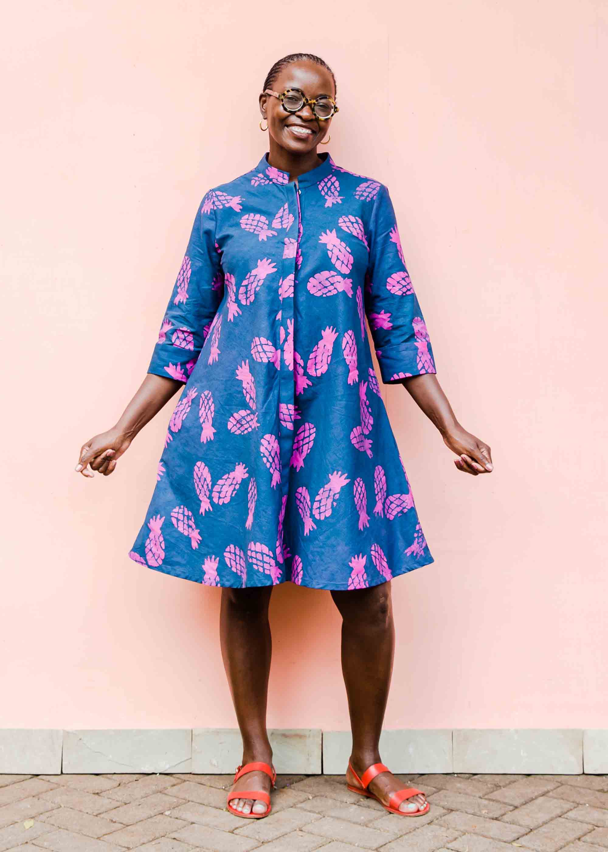 model wearing a pink and blue pineapple dress 