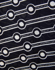 Close up display of white and black geometric print dress