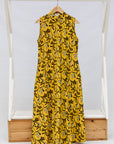 Display of yellow dress with black and white paisley print.