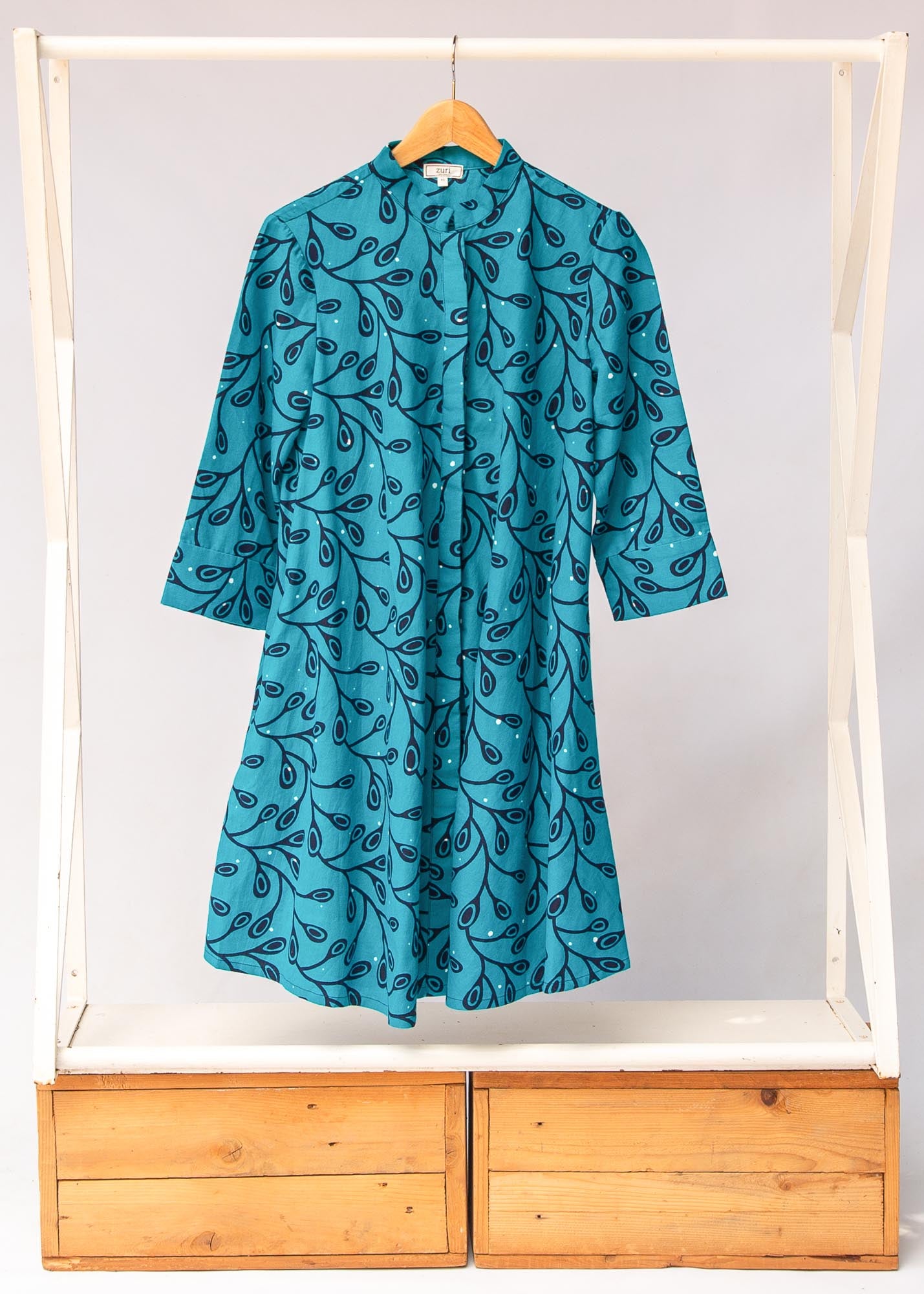 Display of teal leaf print dress