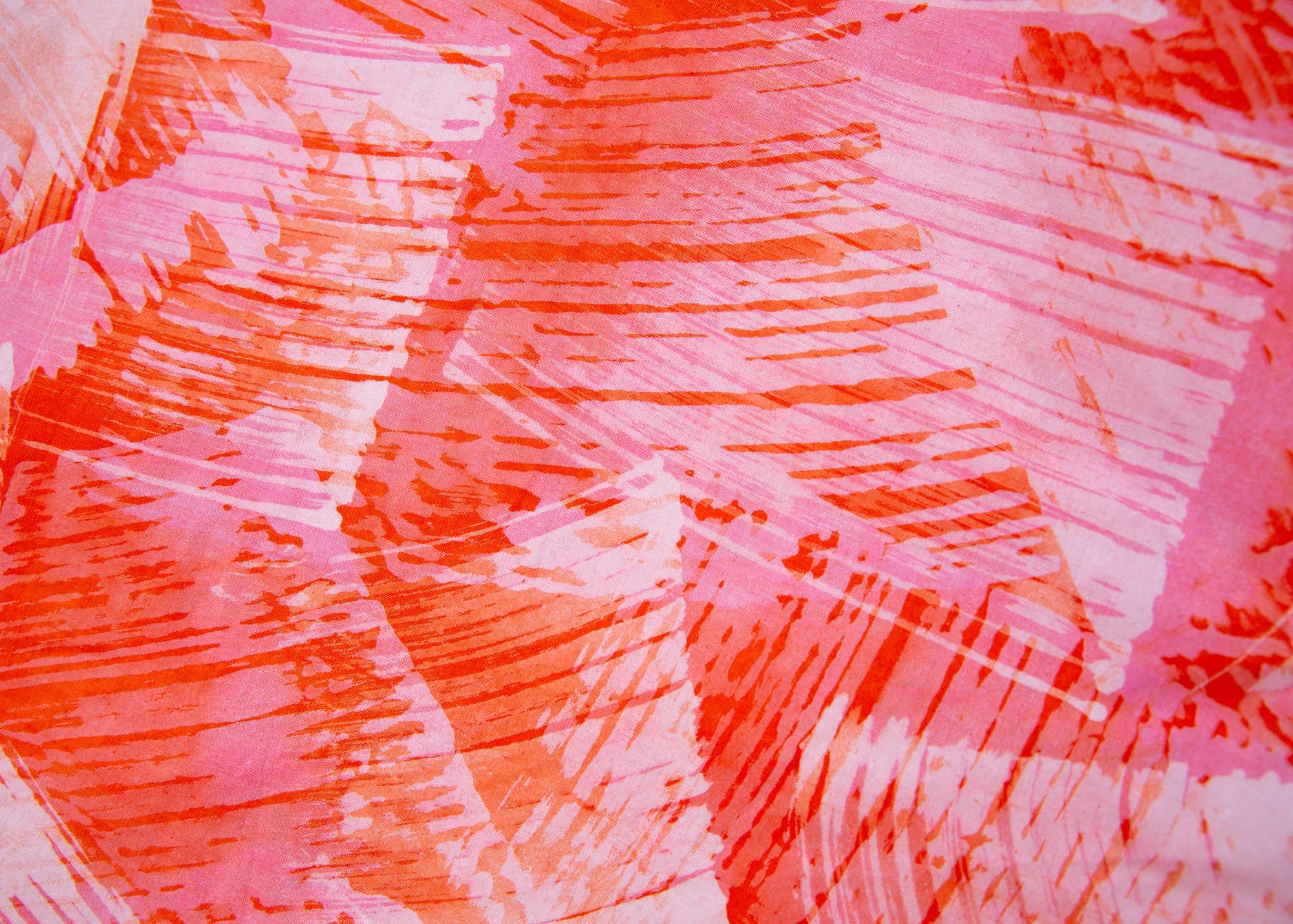 Close up display of orange, pink and white brushstrokes batik dress 