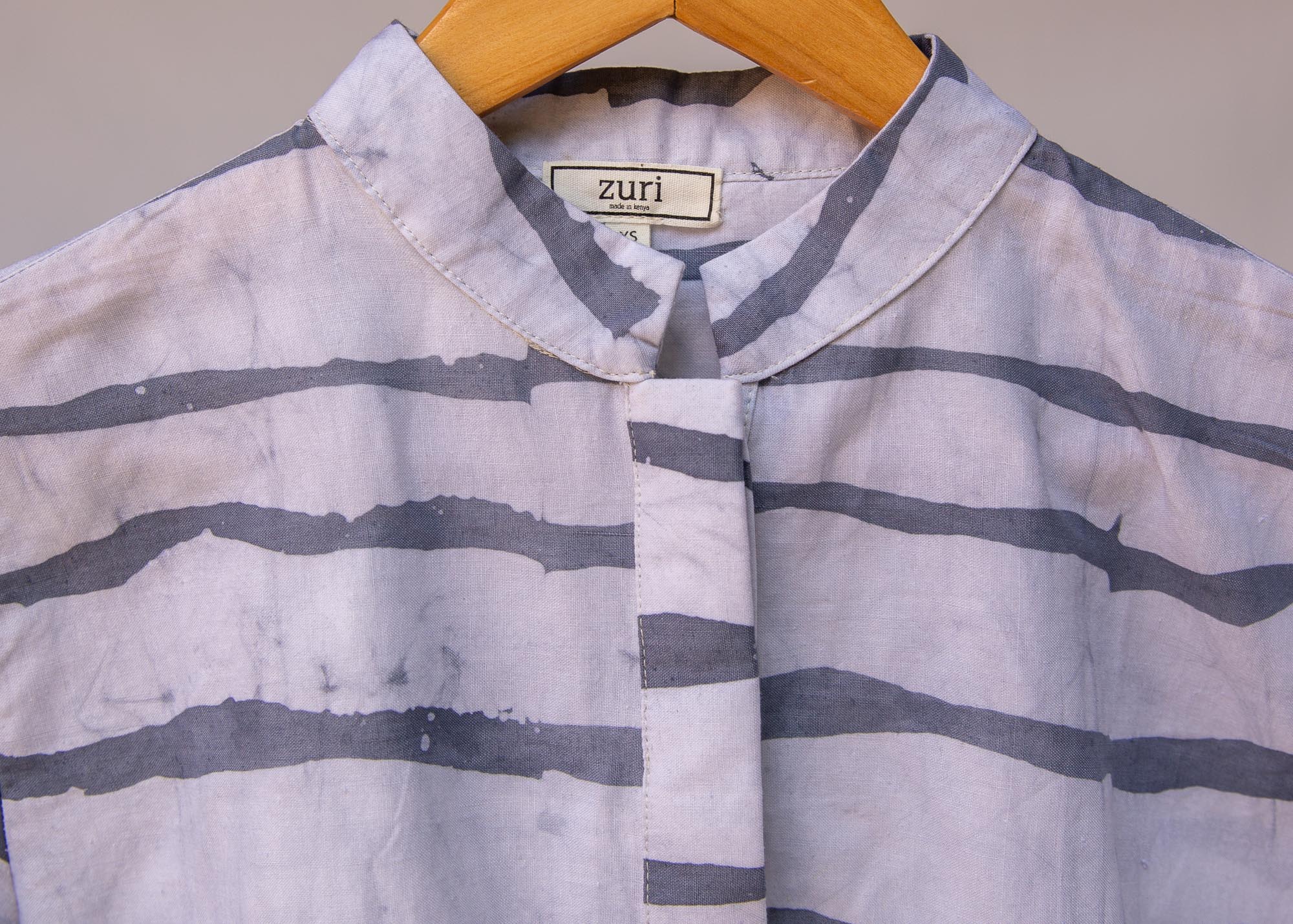 Display of gray and white striped batik shirt