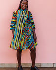 The model is wearing pop art colored geometric print