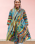 The model is wearing pop art colored geometric print