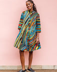 The model is wearing pop art colored geometric print