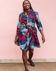 The model is wearing multi-colored geometric print dress