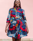 The model is wearing multi-colored geometric print dress