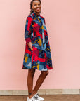 The model is wearing multi-colored geometric print dress