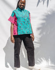 The model is wearing black, pink, sky blue, white, purple print shirt