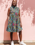 The model is wearing black, yellow, blue, red, pink print dress
